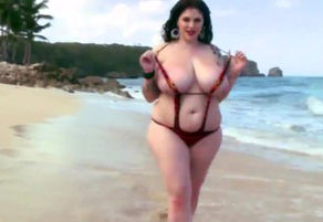 Sensual plump girlposing on beach